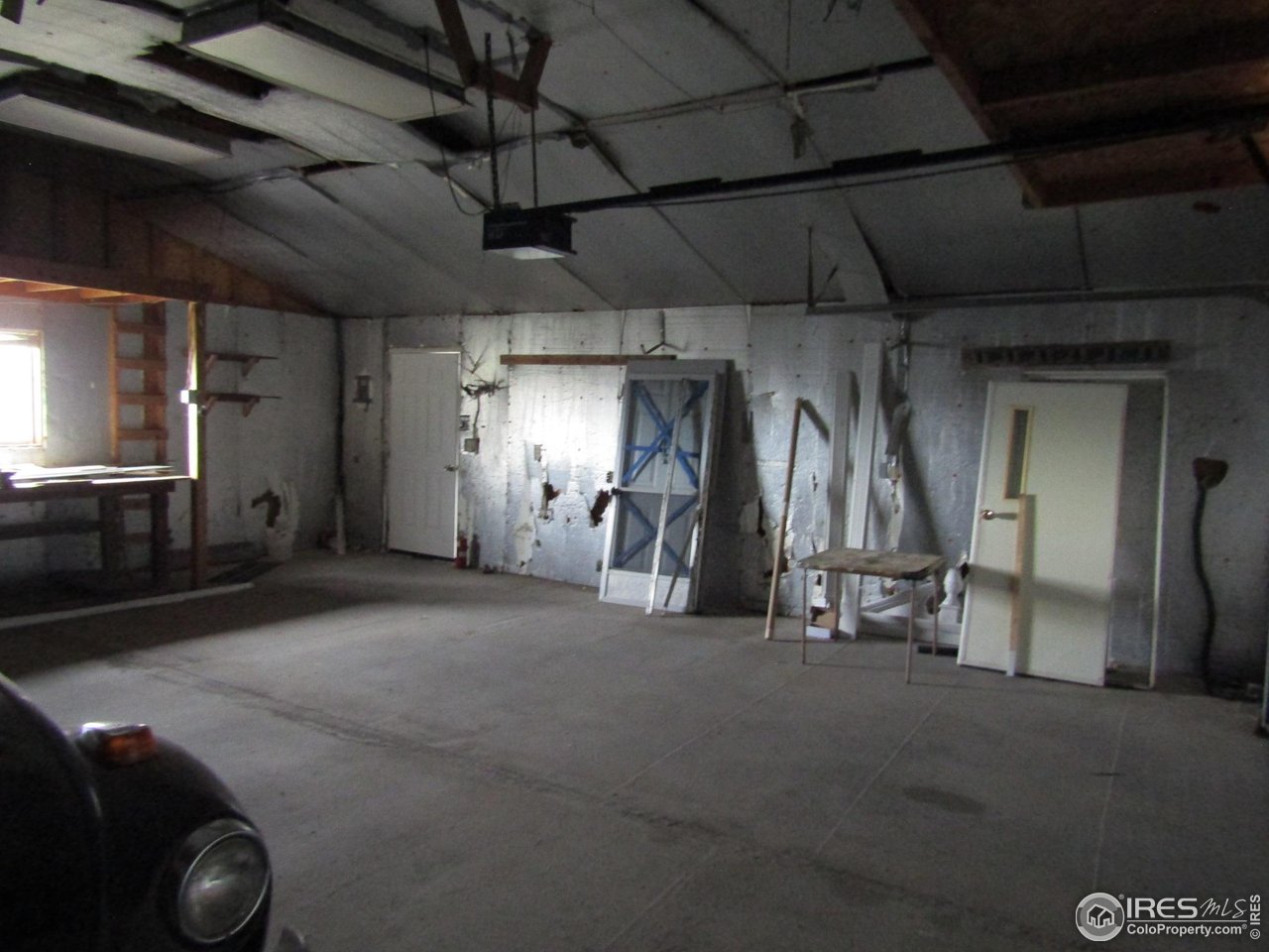 18500 Centennial Road Fort Morgan, CO 80701 - Photo 35 of 37 Garage interior/workbench under window/storage above