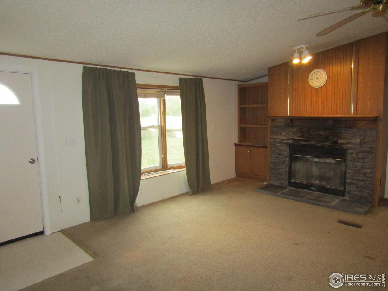 18500 Centennial Road Fort Morgan, CO 80701 - Photo 8 of 37 New front door/living room/fireplace