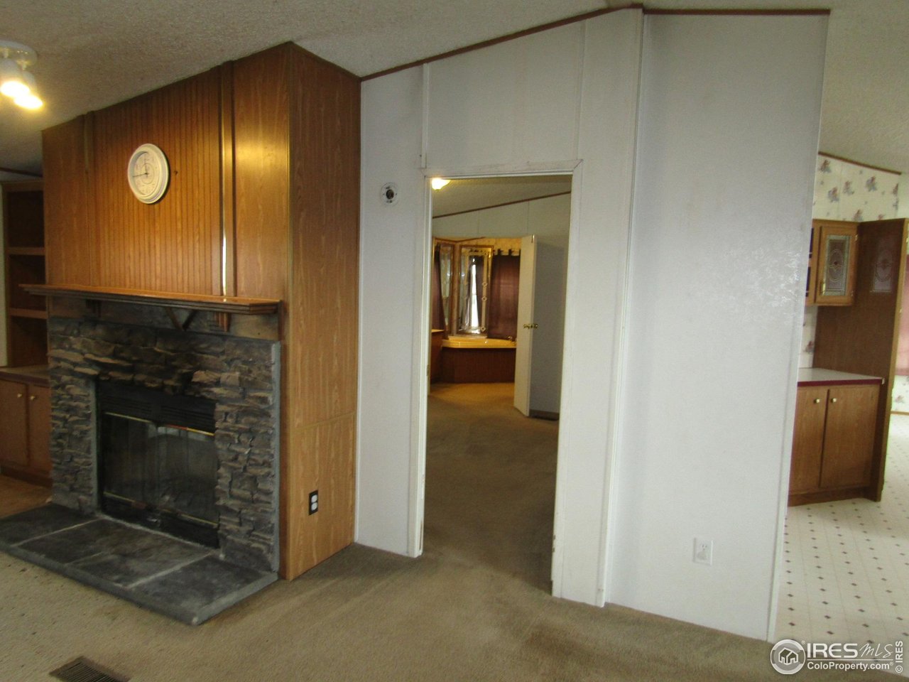 18500 Centennial Road Fort Morgan, CO 80701 - Photo 9 of 37 Primary bedroom/bathroom in background/kitchen at right.
