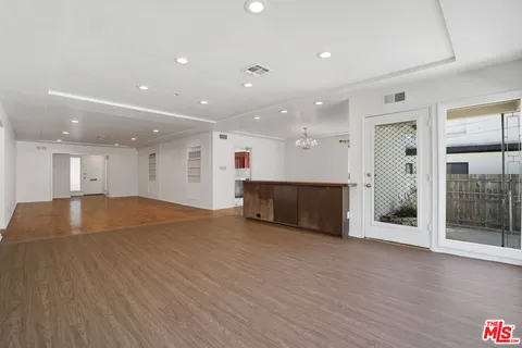 a view of a kitchen with a sink and a window