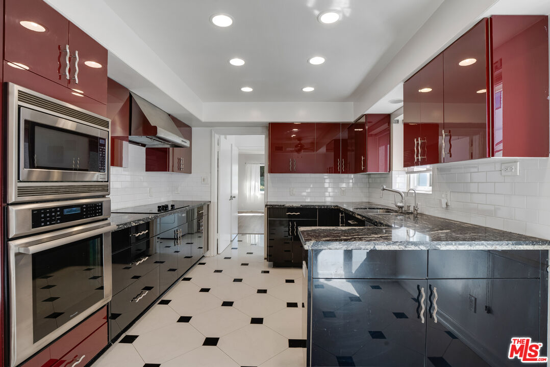 1617 Reeves Street Los Angeles, CA 90035 - Photo 19 of 55 a kitchen with a sink a stove and cabinets
