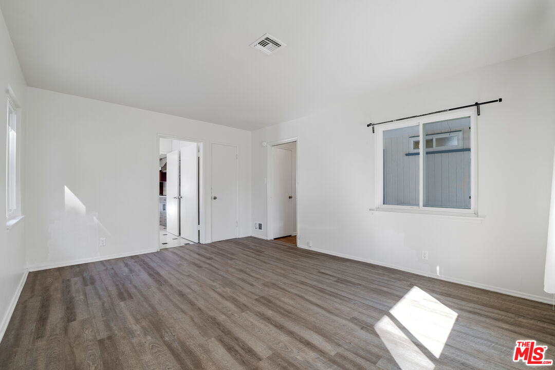1617 Reeves Street Los Angeles, CA 90035 - Photo 28 of 55 a view of an empty room with wooden floor and a window