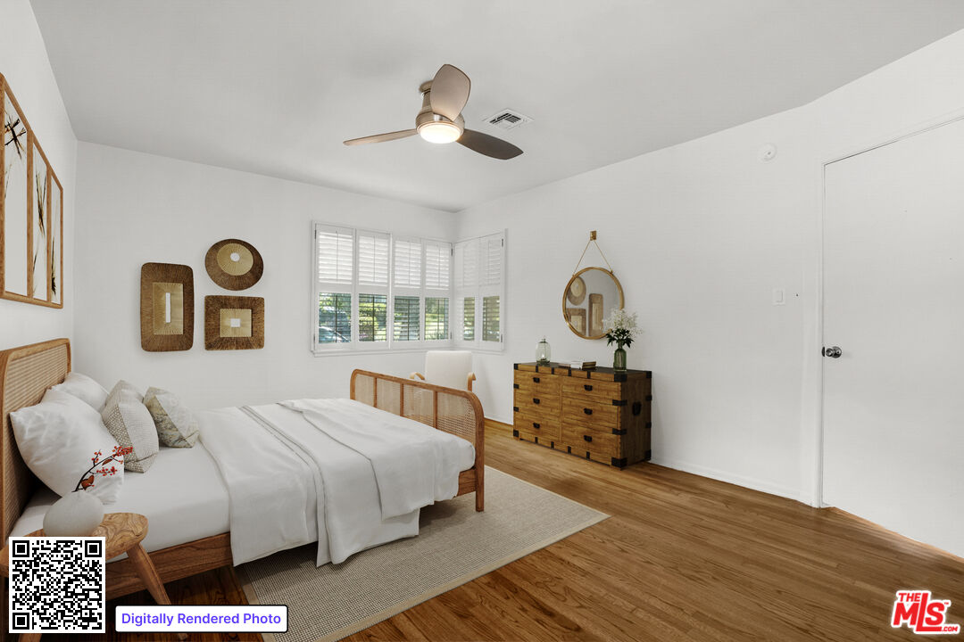 1617 Reeves Street Los Angeles, CA 90035 - Photo 32 of 55 a bedroom with a bed and wooden floor