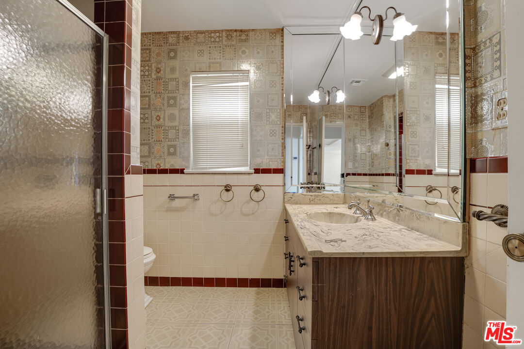 1617 Reeves Street Los Angeles, CA 90035 - Photo 35 of 55 a bathroom with a sink and a mirror