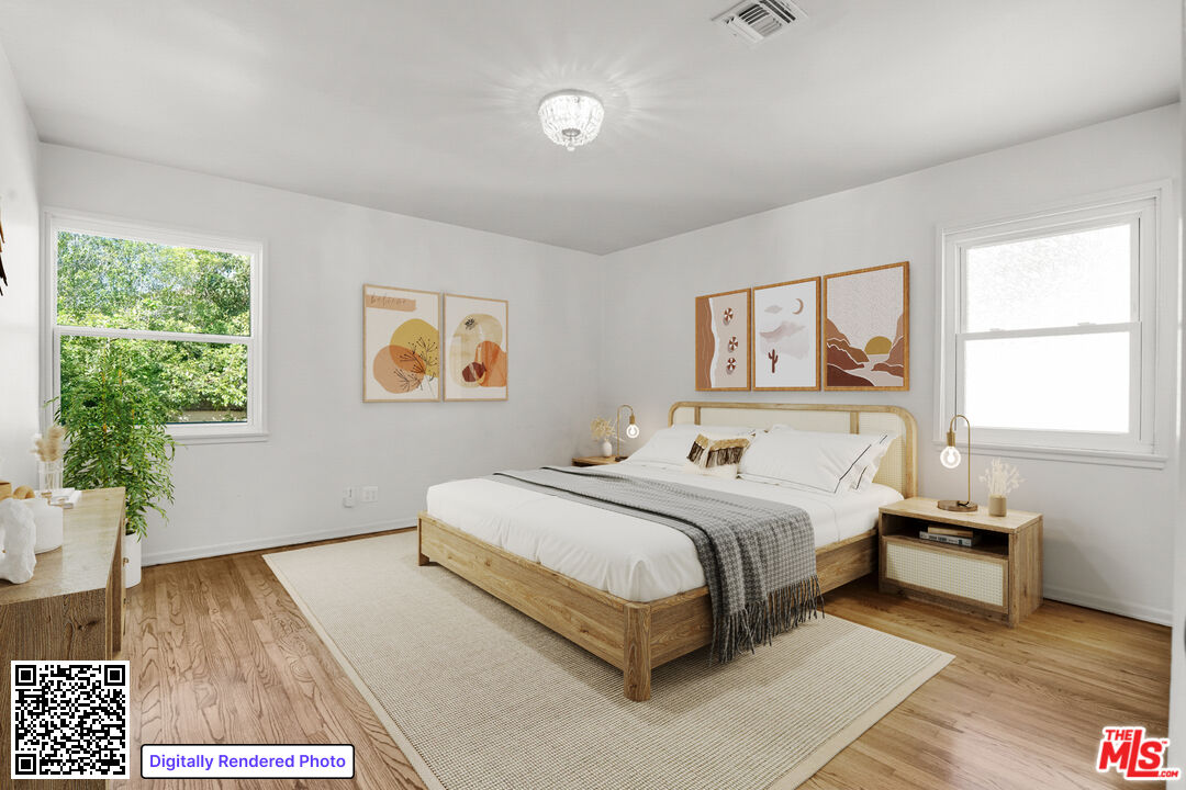 1617 Reeves Street Los Angeles, CA 90035 - Photo 37 of 55 a spacious bedroom with a large bed and a wooden floor