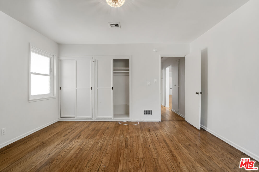 1617 Reeves Street Los Angeles, CA 90035 - Photo 39 of 55 an empty room with wooden floor and windows