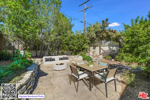a backyard of a house with plants and trees