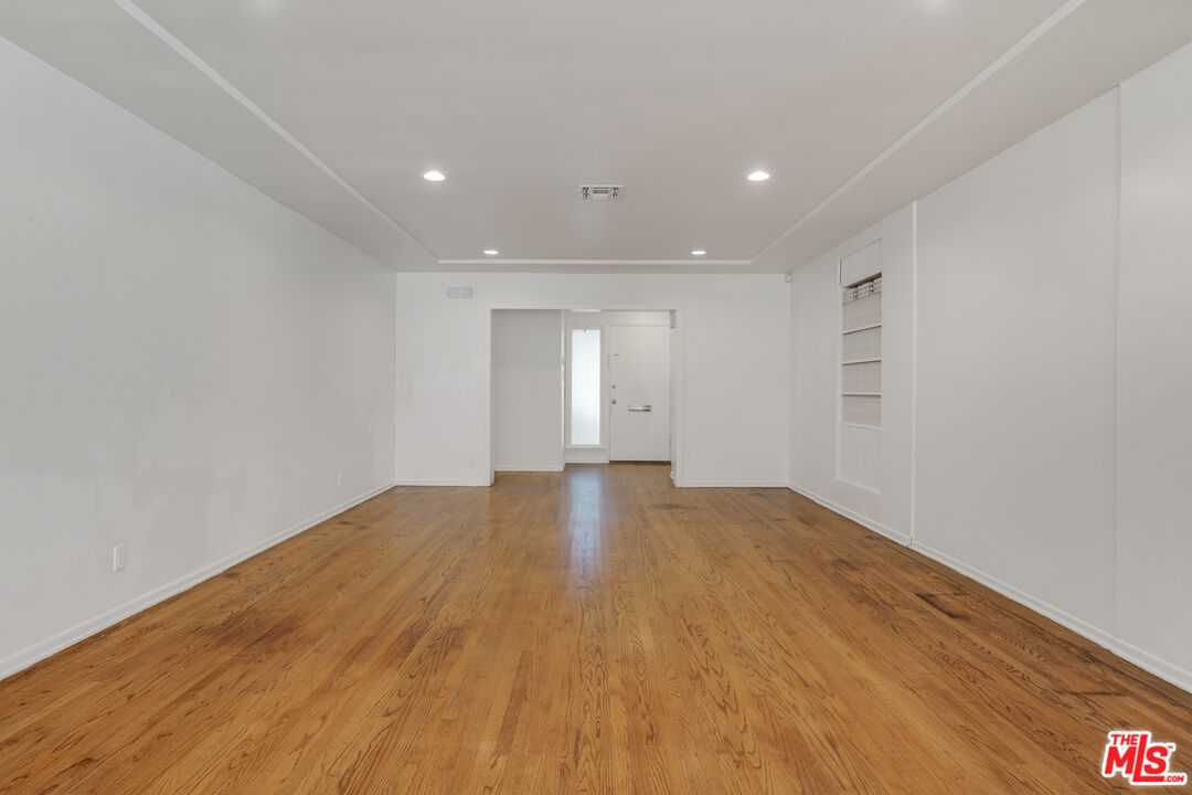 1617 Reeves Street Los Angeles, CA 90035 - Photo 8 of 55 a view of an empty room with wooden floor