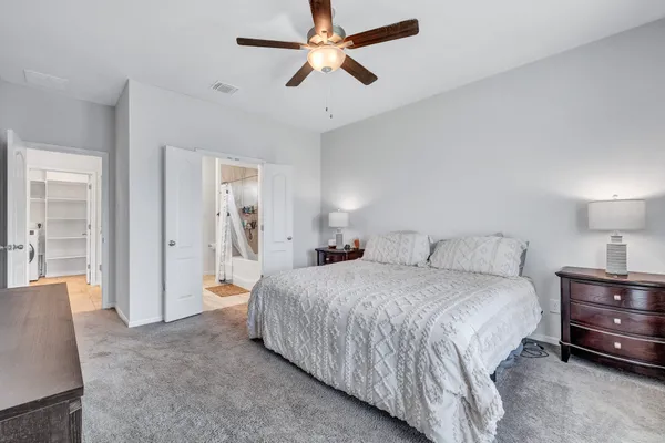 a bedroom with a bed and a chandelier