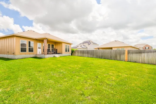 a view of a house with a backyard porch and sitting area
