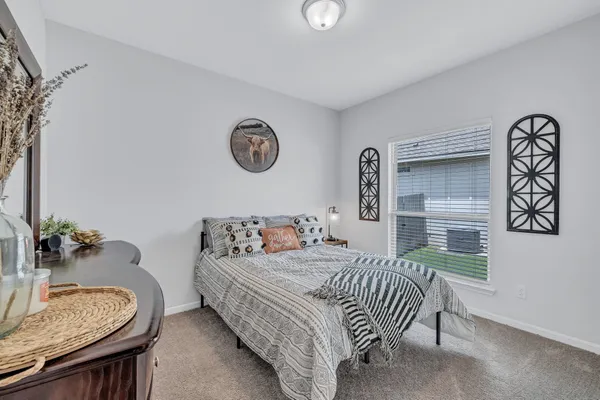 a bedroom with a bed and a table