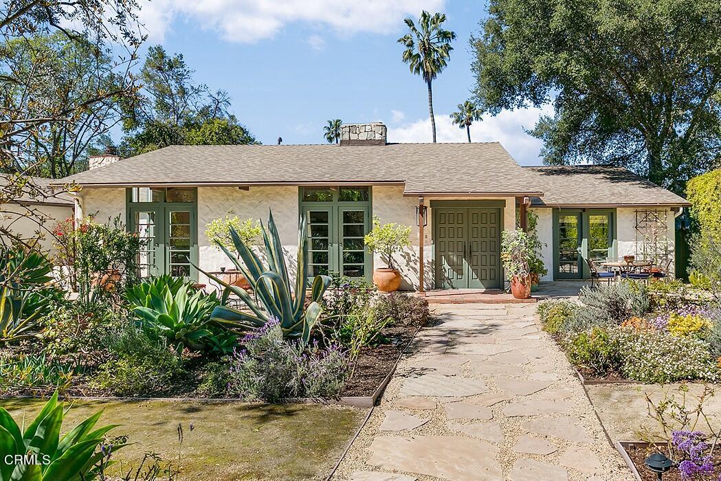 a front view of a house with garden