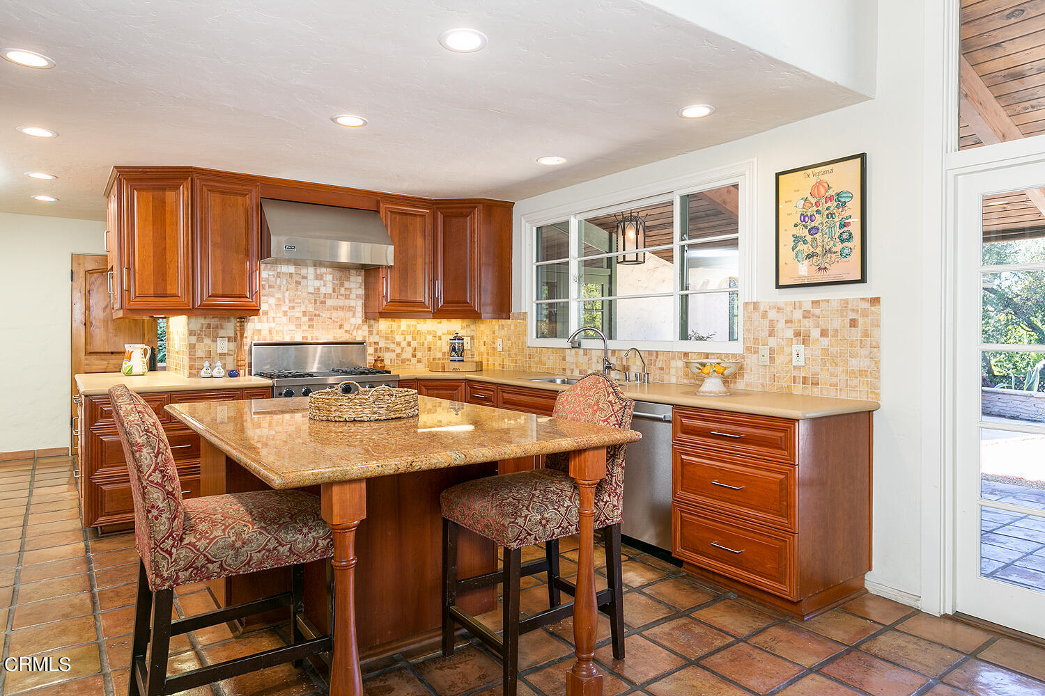 625 Burleigh Drive Pasadena, CA 91105 - Photo 20 of 43 a kitchen with stainless steel appliances kitchen island granite countertop a table chairs sink and cabinets