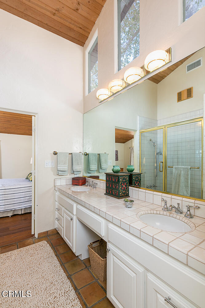 625 Burleigh Drive Pasadena, CA 91105 - Photo 26 of 43 a bathroom with a sink a mirror and a shower