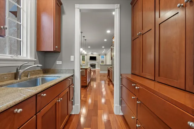 a kitchen with stainless steel appliances granite countertop a refrigerator a stove top oven and a sink with cabinets