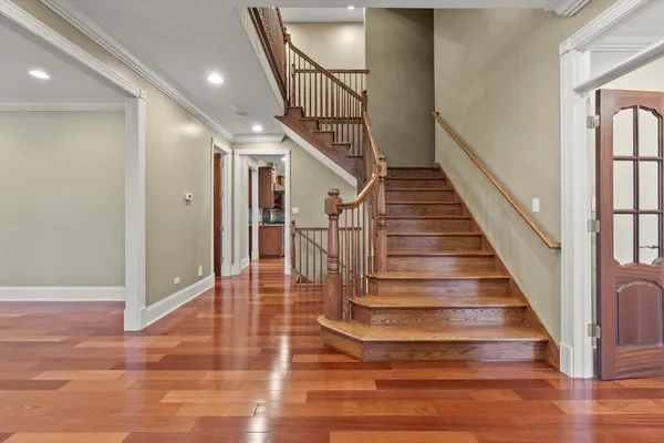 a view of entryway and hall with wooden floor