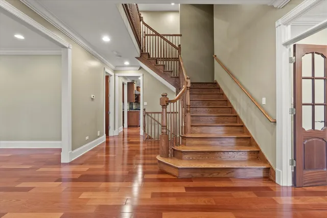 a view of entryway and hall with wooden floor