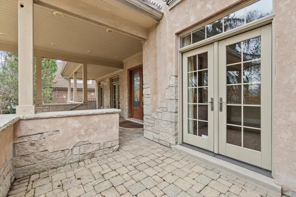 a kitchen with stainless steel appliances kitchen island granite countertop wooden floors wooden cabinets and sink