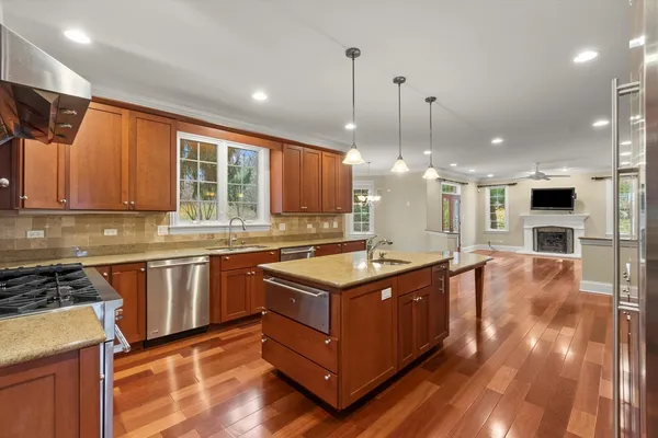 a large kitchen with lots of counter space a sink and appliances
