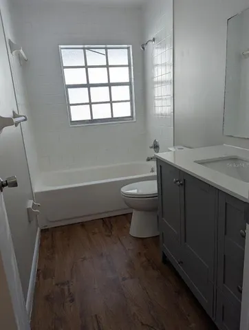 a bathroom with a toilet a sink and bathtub
