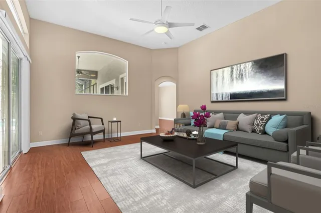 a view of a room with wooden floor and large windows