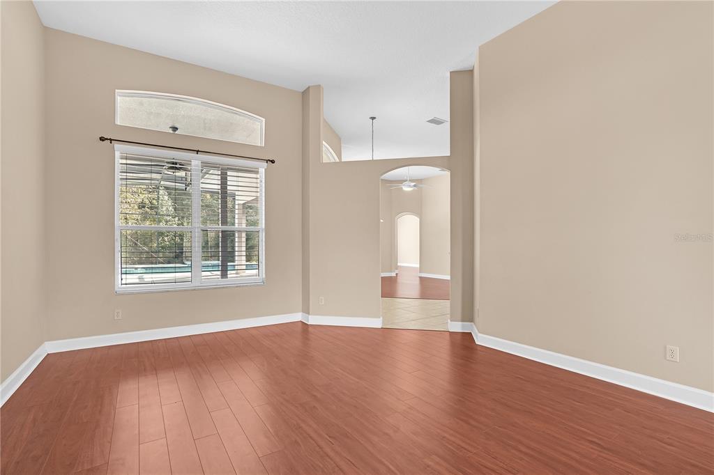 1542 Wescott Loop Winter Springs, FL 32708 - Photo 13 of 62 a view of an empty room with wooden floor and a window