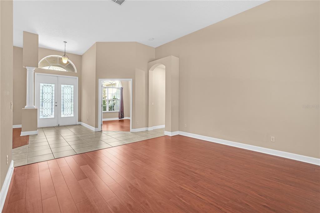 1542 Wescott Loop Winter Springs, FL 32708 - Photo 16 of 62 a view of a room with wooden floor and large windows