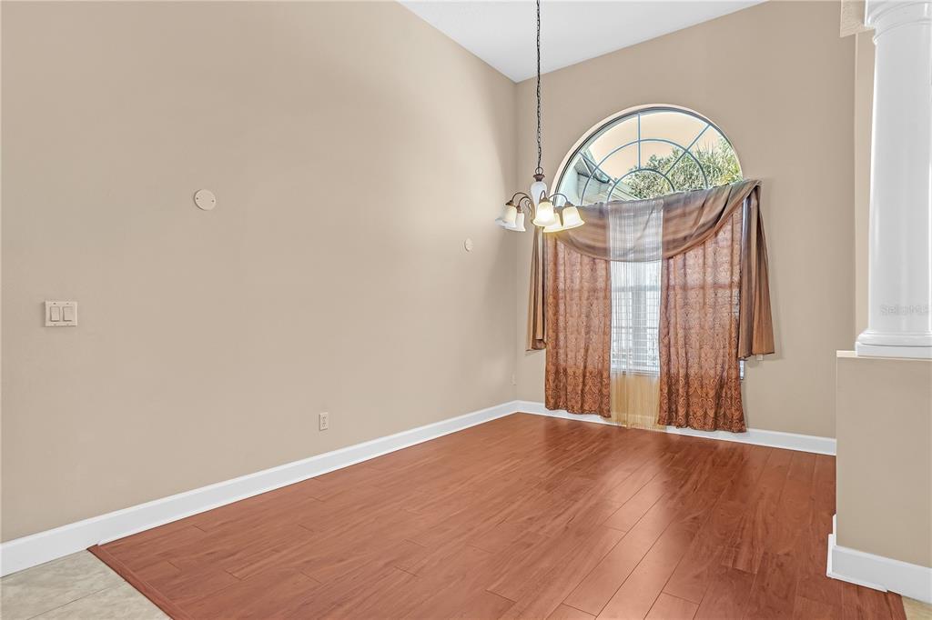 1542 Wescott Loop Winter Springs, FL 32708 - Photo 17 of 62 an empty room with wooden floor windows and exposed bricks