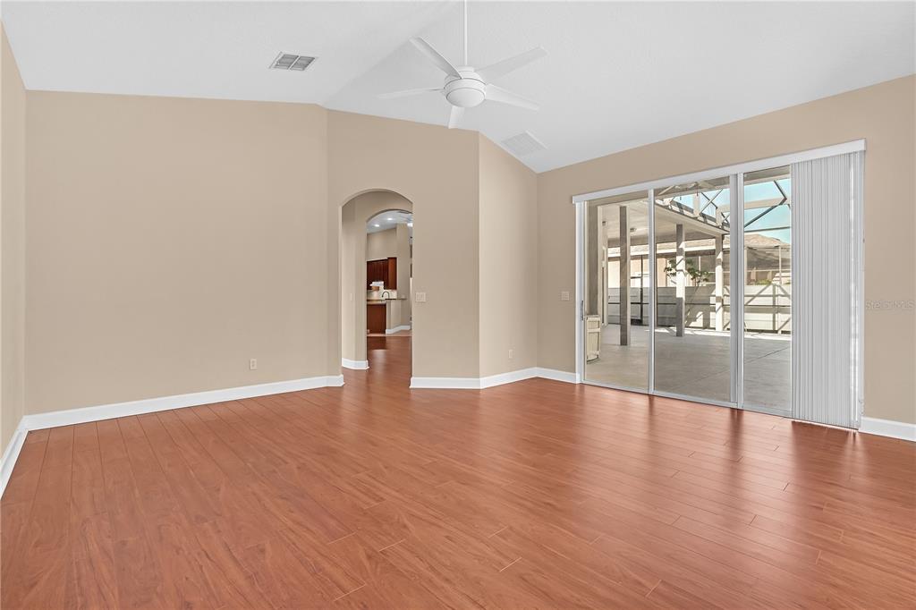 1542 Wescott Loop Winter Springs, FL 32708 - Photo 30 of 62 an empty room with wooden floor and a floor to ceiling window