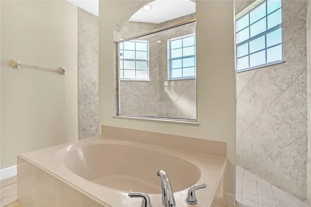 an aerial view of residential houses with outdoor space and parking