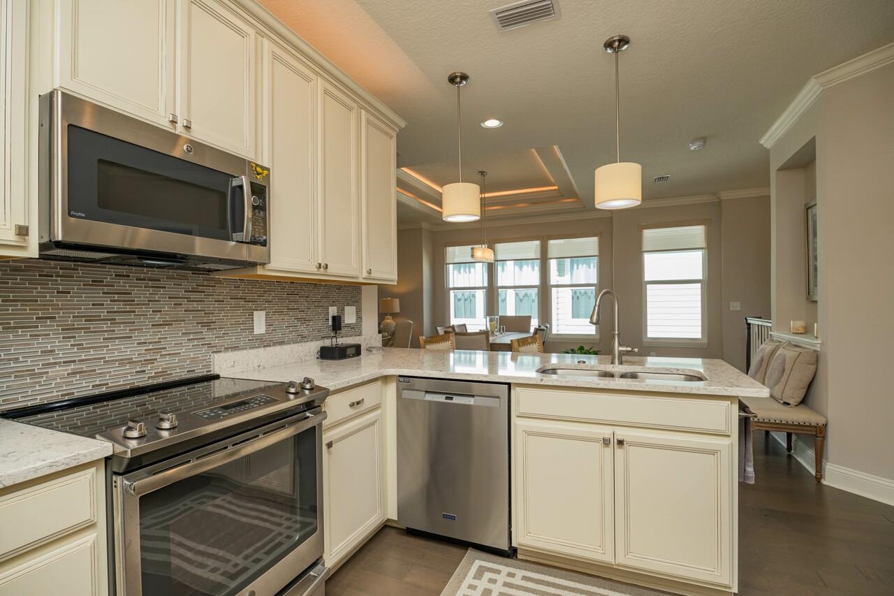 223 Sunset Point St. Augustine, FL 32080 - Photo 16 of 74 a kitchen with stainless steel appliances a stove microwave and sink