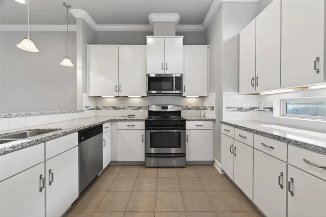 a kitchen with cabinets stainless steel appliances and a sink