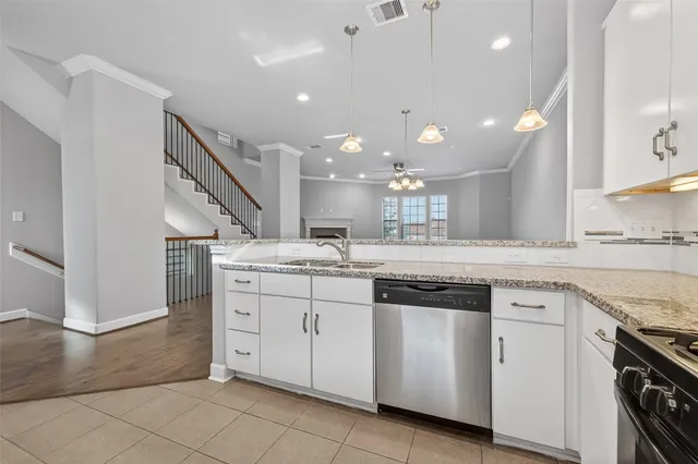 a kitchen with a sink stove and cabinets