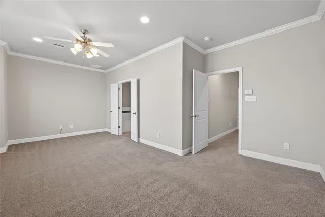 a view of an empty room with a ceiling fan