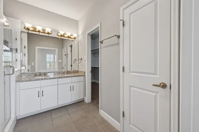 a bathroom with a double vanity sink and mirror