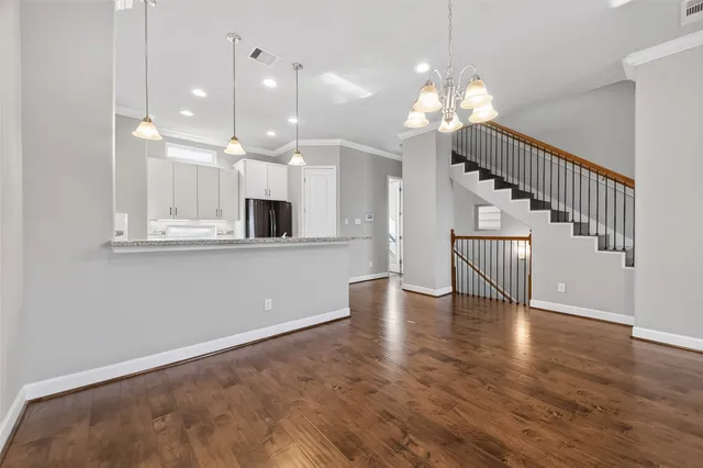 a view of a room with wooden floor and staircase