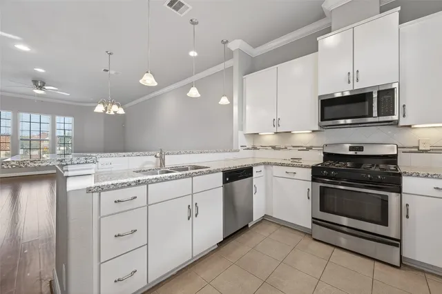 a kitchen with a sink stove and microwave