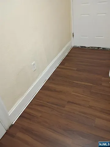 an empty room with wooden floor