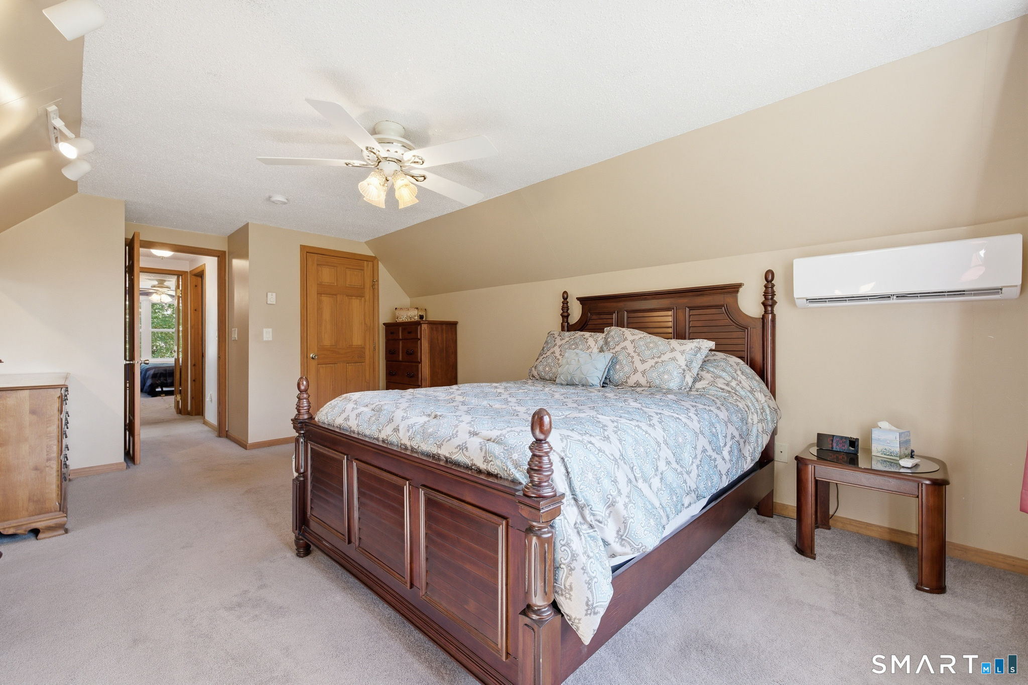141 Hop River Road Coventry, CT 06238 - Photo 17 of 40 a spacious bedroom with a bed and a chandelier