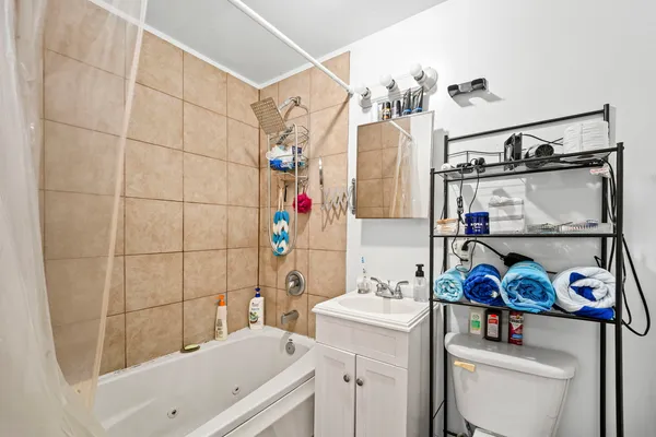 a bathroom with a sink a toilet and shower curtain