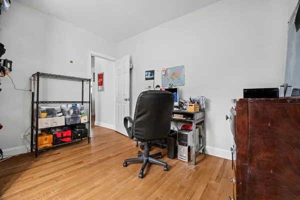 a view of a workspace with furniture and wooden floor