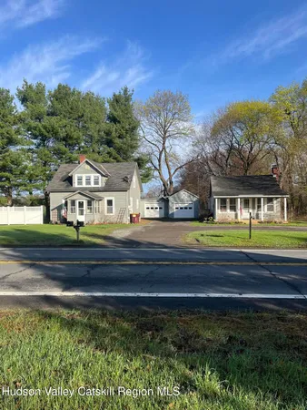 a front view of a house with a yard covered in snow