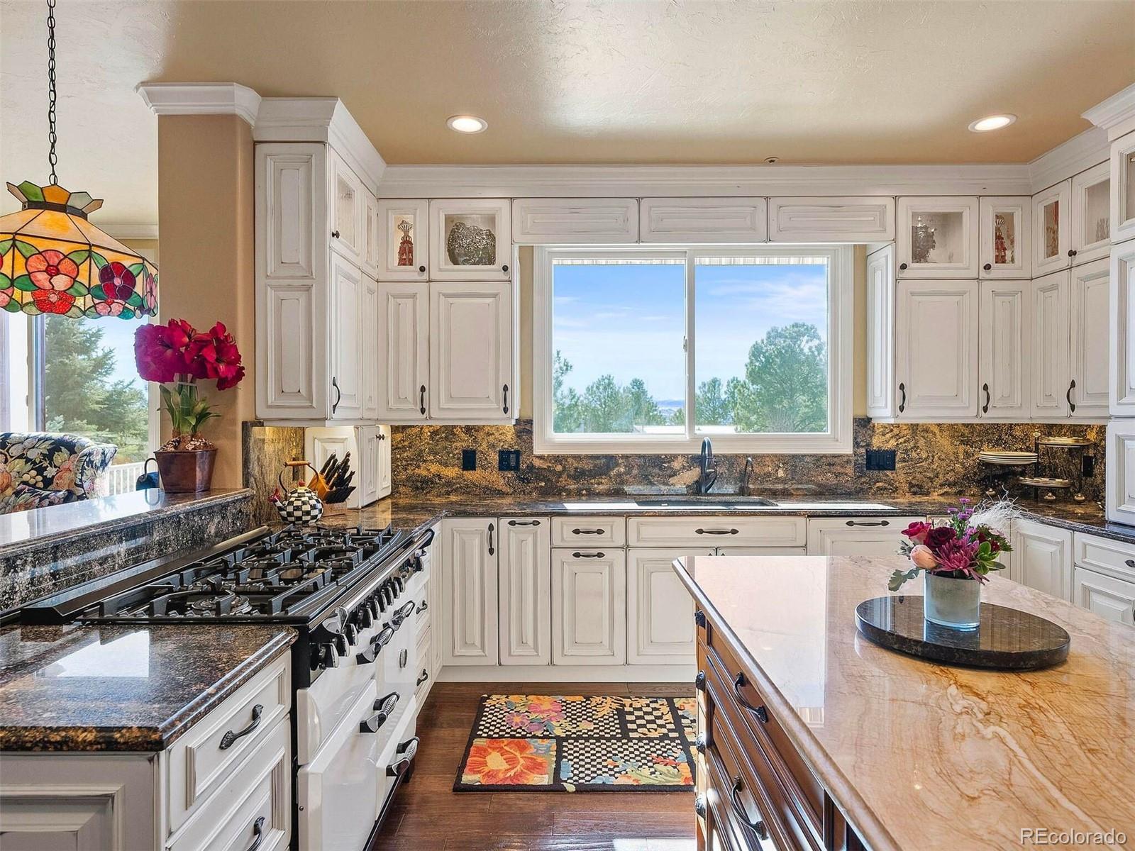 2124 Ridge Plaza Drive Castle Rock, CO 80108 - Photo 18 of 50 a kitchen with a stove a sink and cabinets