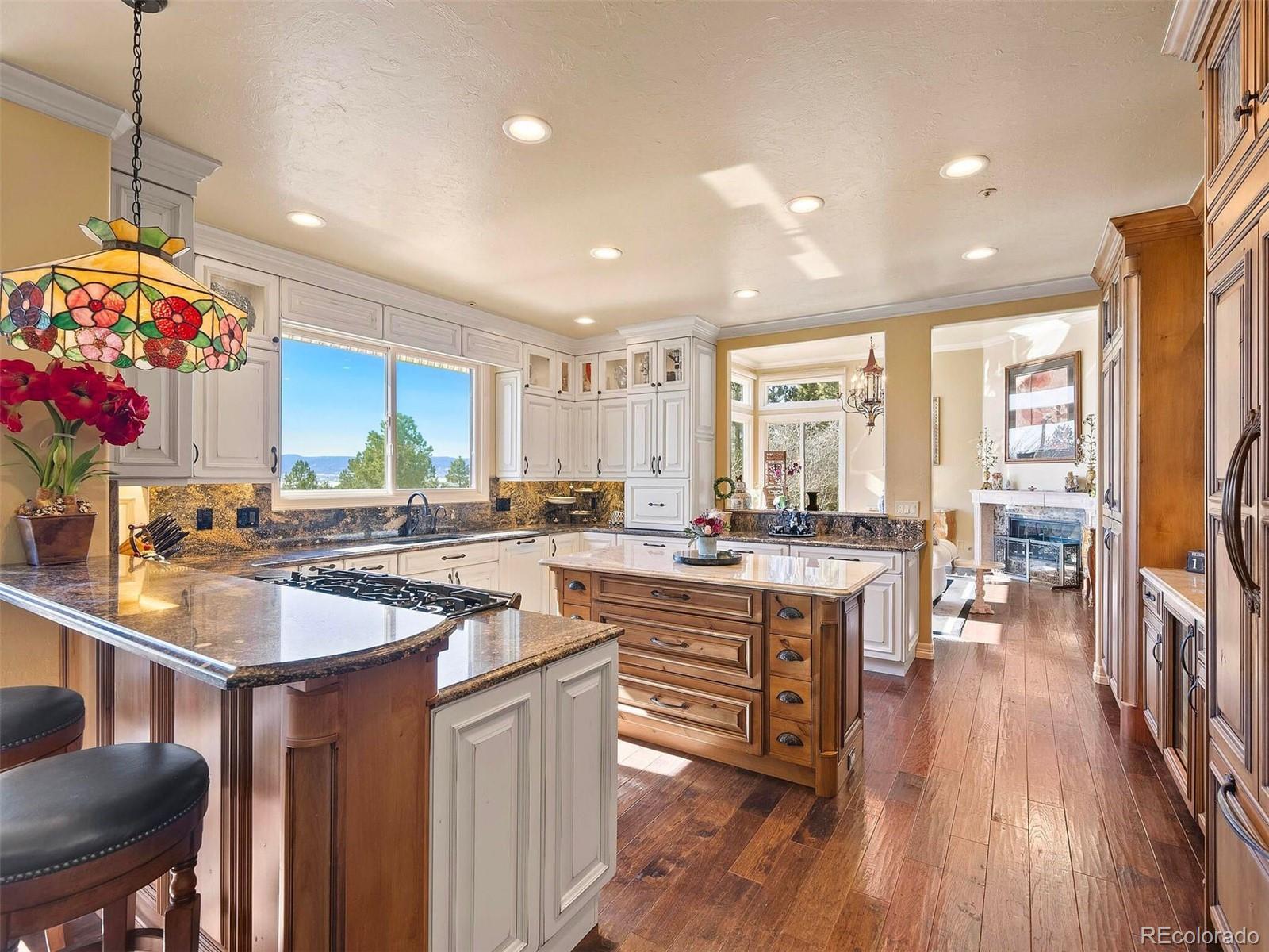 2124 Ridge Plaza Drive Castle Rock, CO 80108 - Photo 19 of 50 a kitchen with counter space sink stove and wooden floor