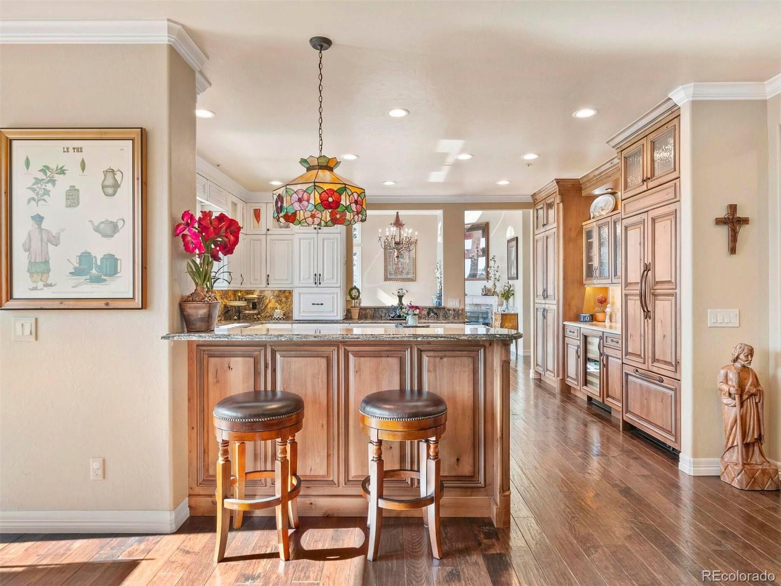 2124 Ridge Plaza Drive Castle Rock, CO 80108 - Photo 21 of 50 a view of a dining room and livingroom with furniture wooden floor a chandelier