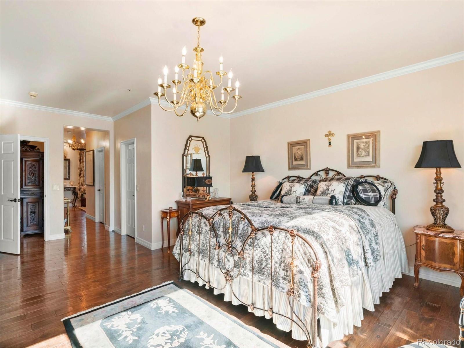 2124 Ridge Plaza Drive Castle Rock, CO 80108 - Photo 26 of 50 a large bedroom with bed and wooden floor