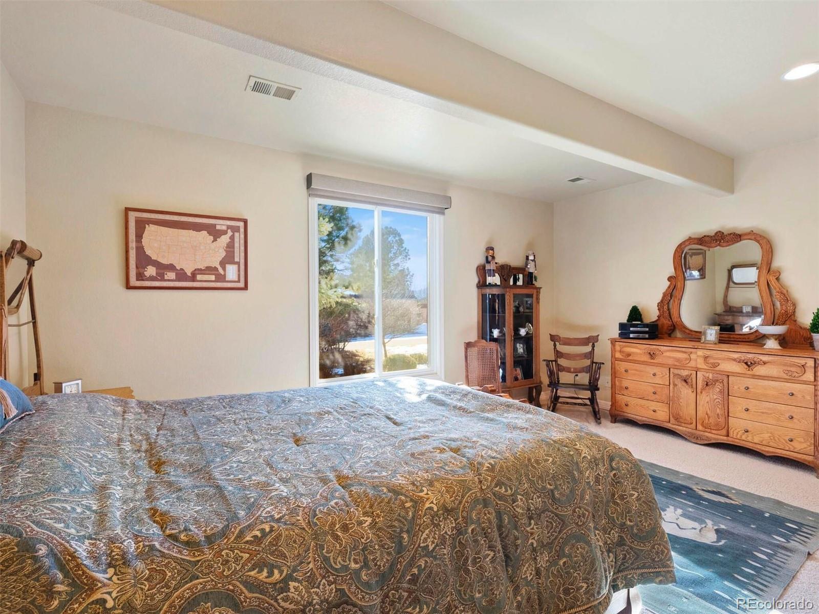 2124 Ridge Plaza Drive Castle Rock, CO 80108 - Photo 35 of 50 a bedroom with a large bed and a dresser