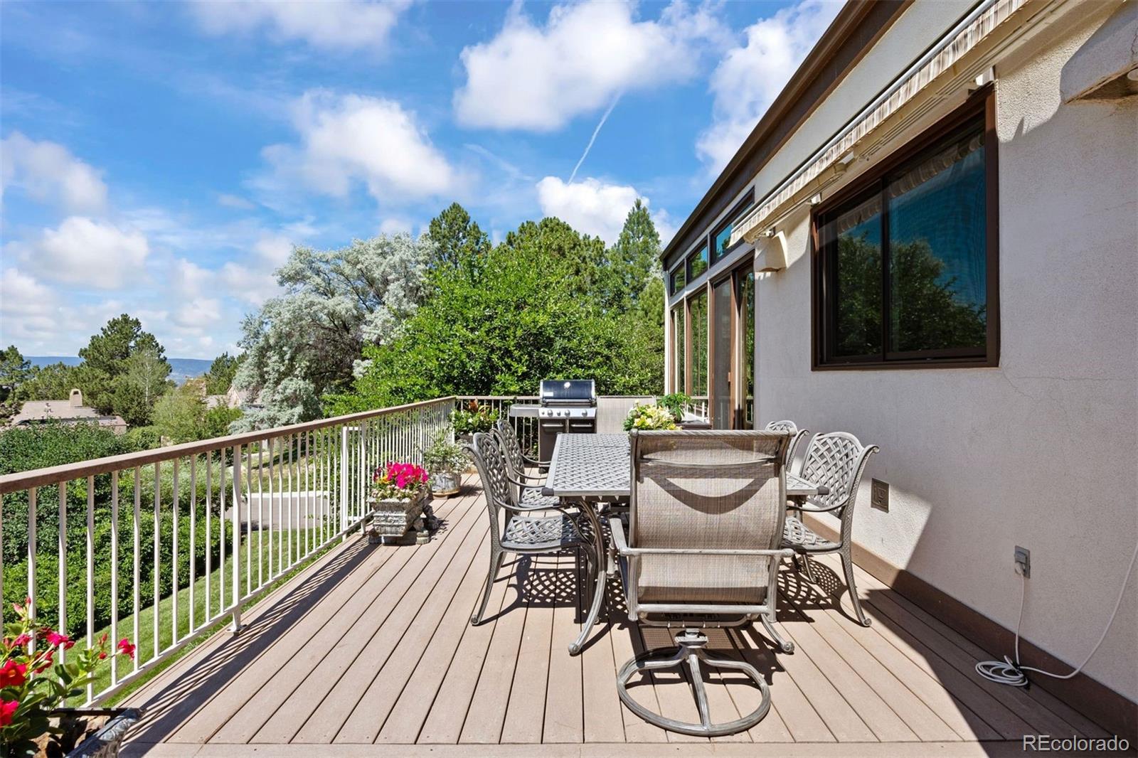 2124 Ridge Plaza Drive Castle Rock, CO 80108 - Photo 43 of 50 a balcony with wooden floor table and chairs