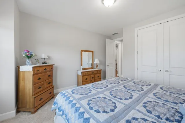 a bedroom with a bed and a large window