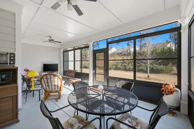 a view of a house with pool and chairs